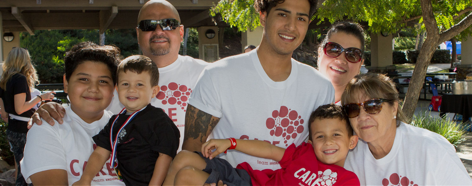 group of happy people wearing angioma alliance shirts