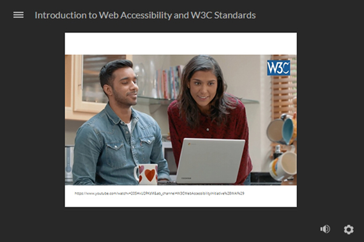 a man and woman looking at laptop